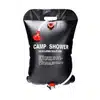 Survival Frog 5-gallon solar shower bag hanging from a tree branch for off-grid camping hygiene