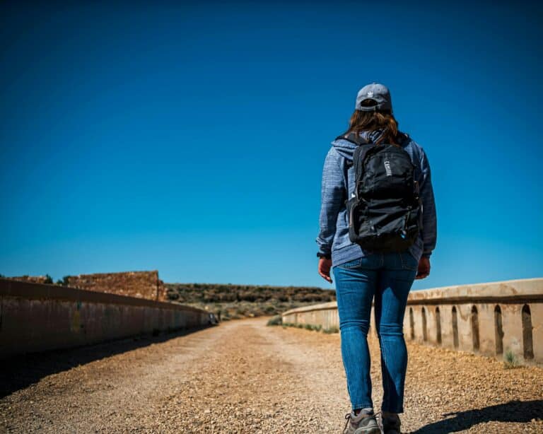 hiker wearing hydration backpack on hot summer hiking trail