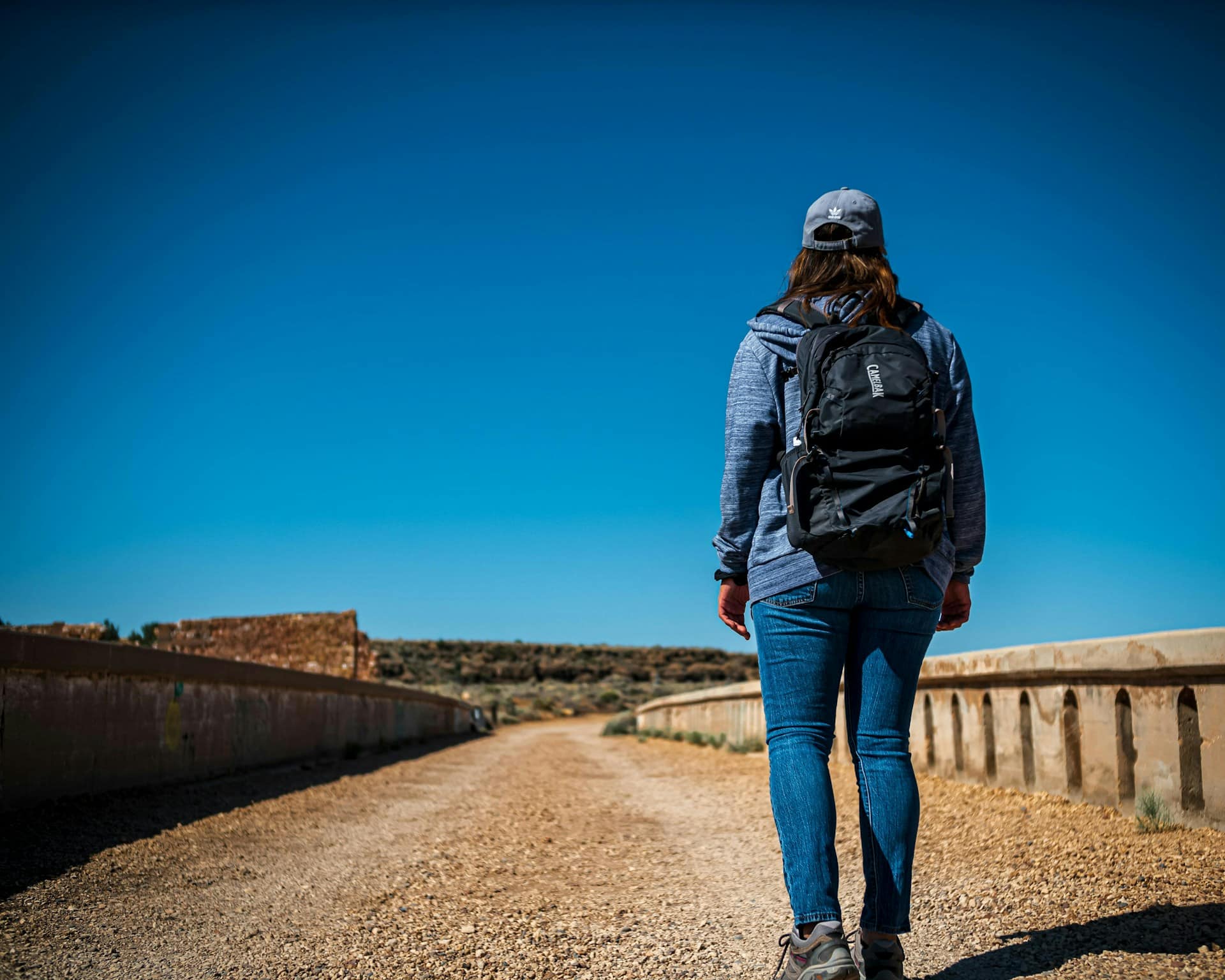 hiker wearing hydration backpack on hot summer hiking trail