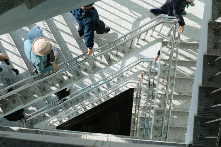 People evacuating a high-rise apartment stairwell during an emergency evacuation in an urban building.